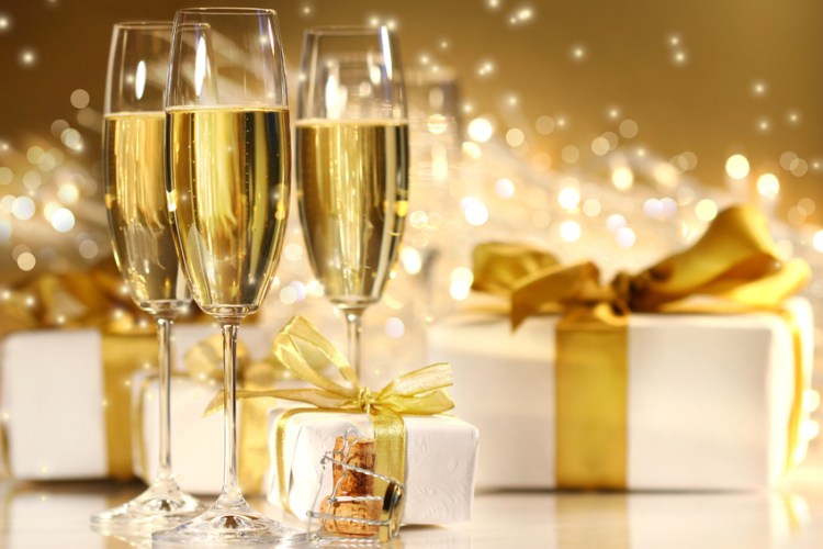 Glasses of champagne with gold ribboned gifts