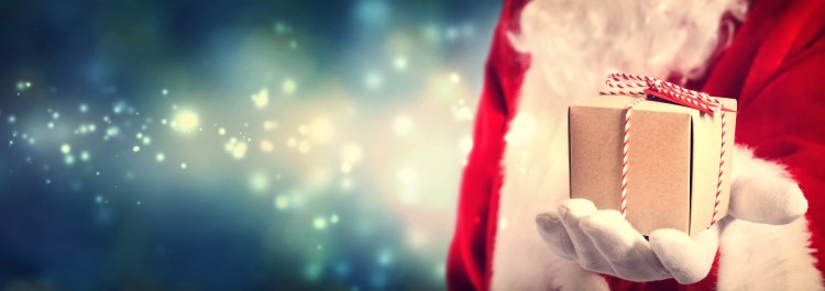 Santa Claus holding a gift in his hand